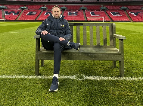 Wembley's Karl Standley sat on bench made from elements of a recycled pitch